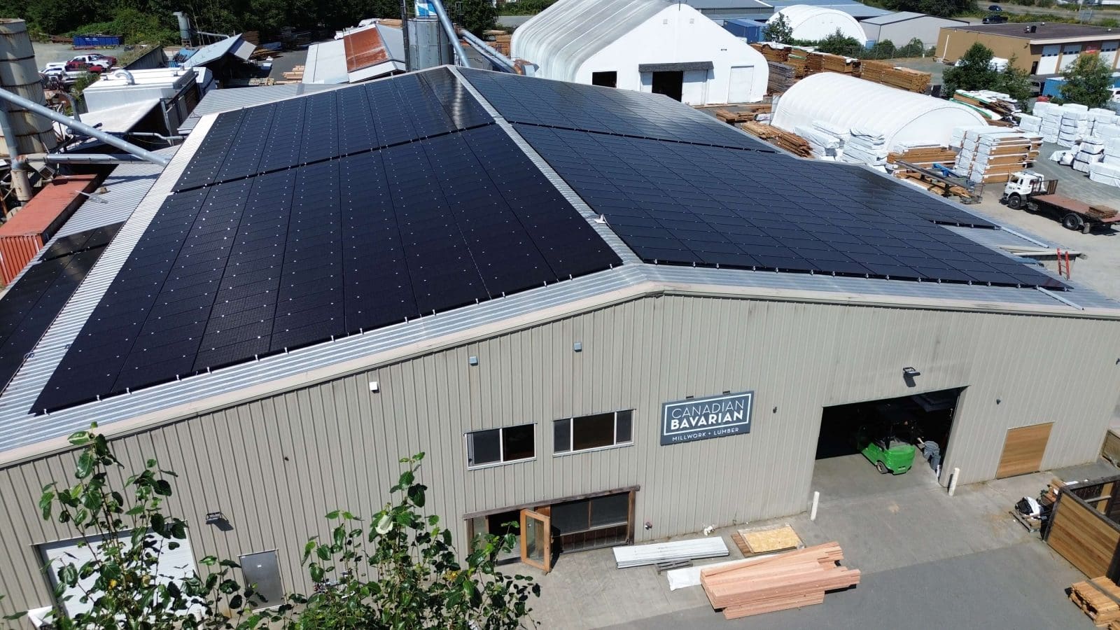 A arial view photo of a business with a metal roof with solar panels on it in Chemainus, BC.