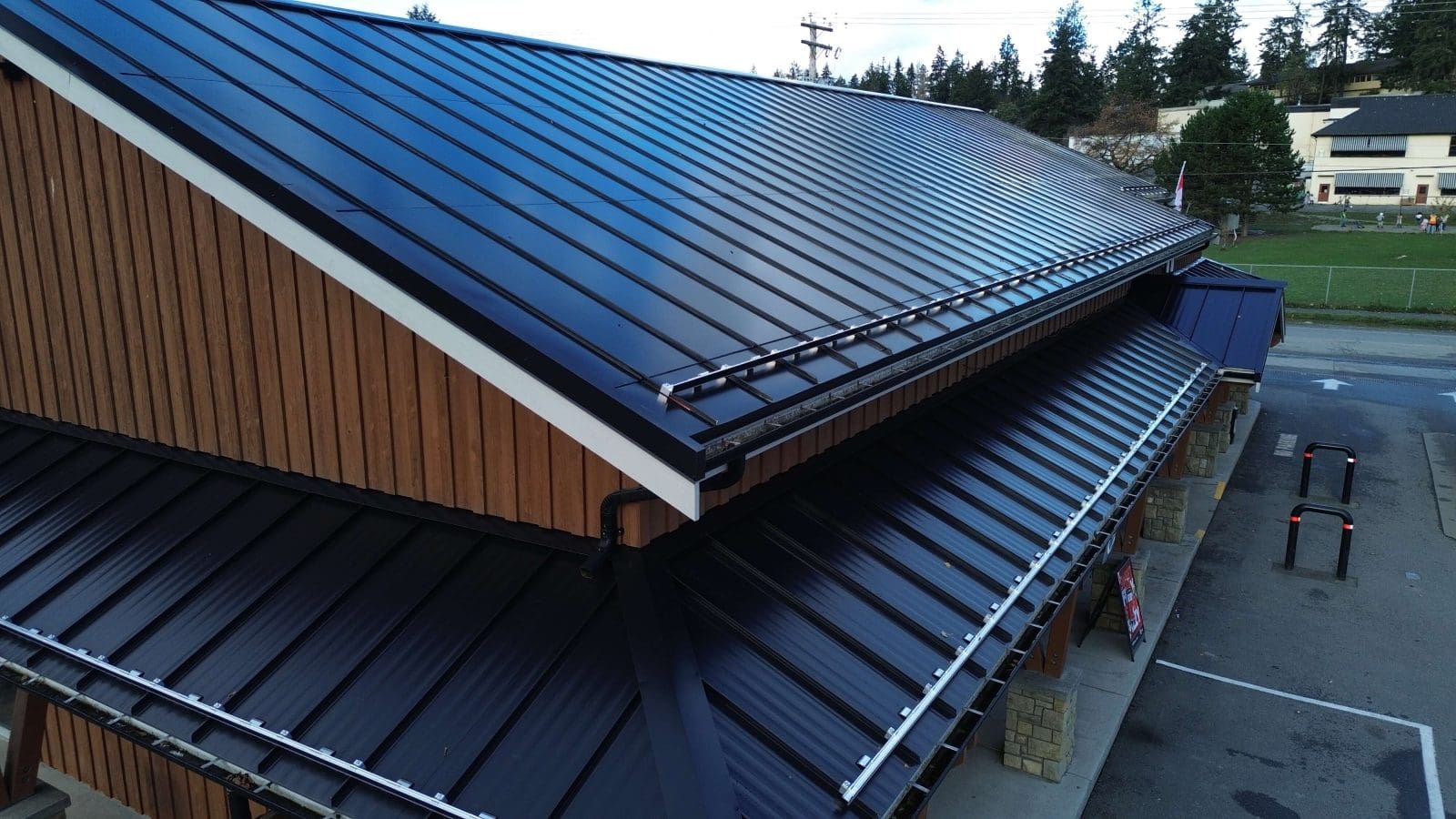 A arial drone photo of a business with BIPV (Building Integrated Photovoltaics) as the roof. A solar panel roof. In Salt Spring, BC