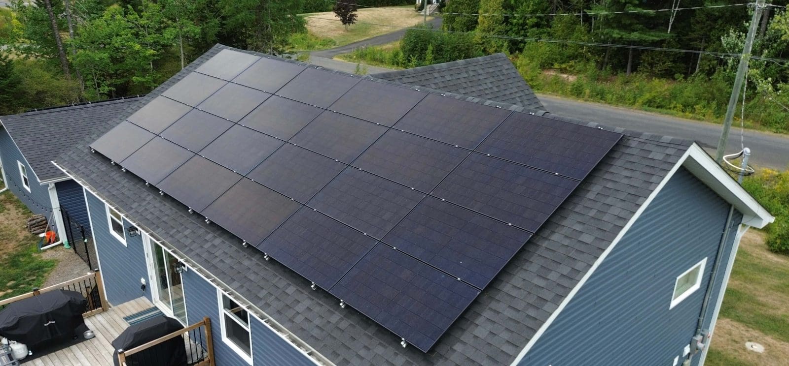 Aerial view of a New Brunswick home with solar panels on the roof.