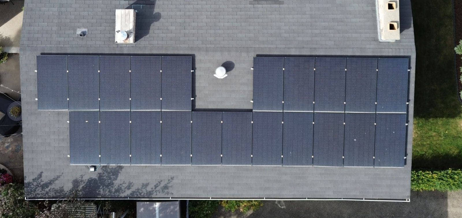 Aerial view of a home with solar panels.