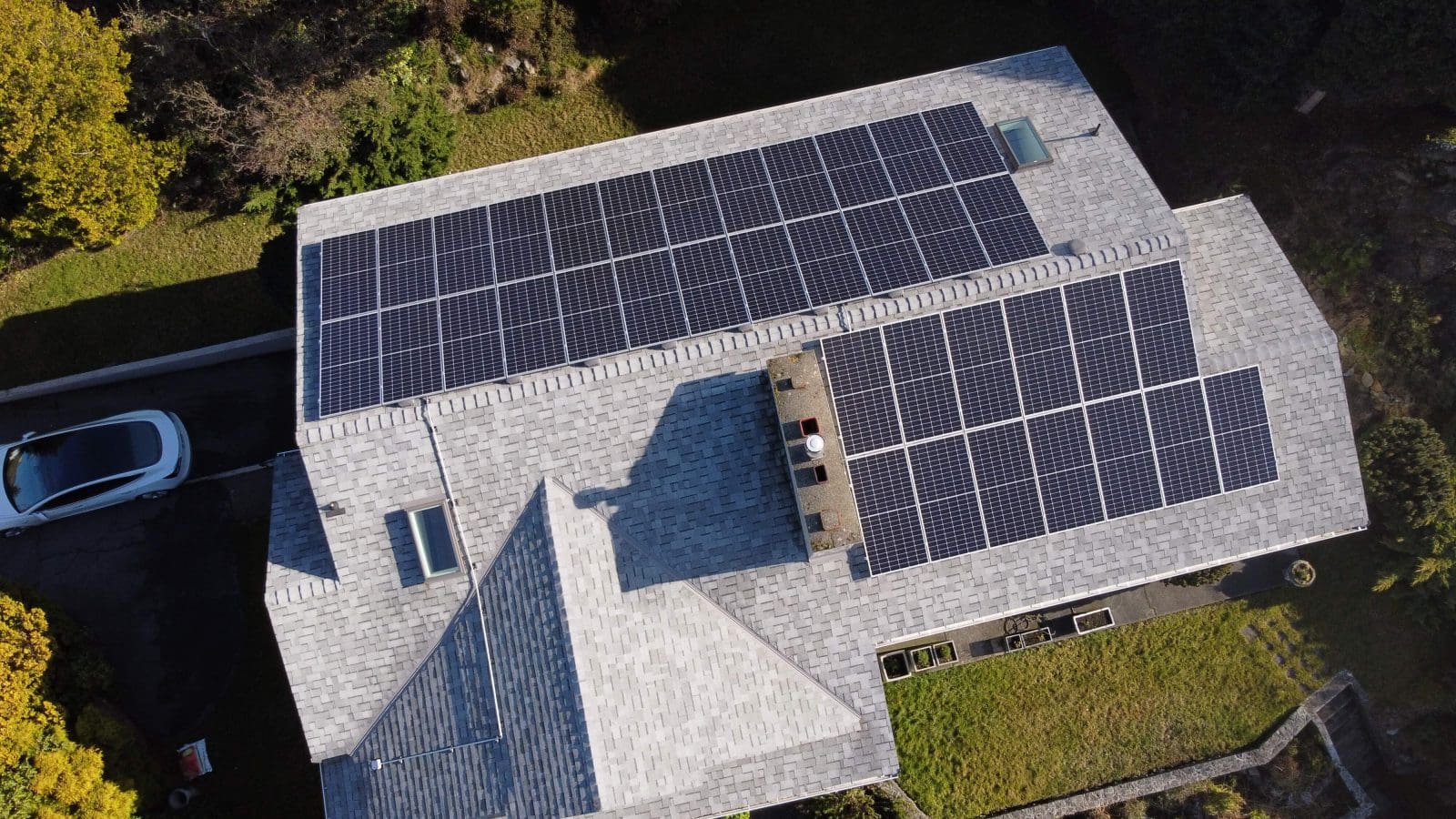 An aerial view of a home with solar panels.