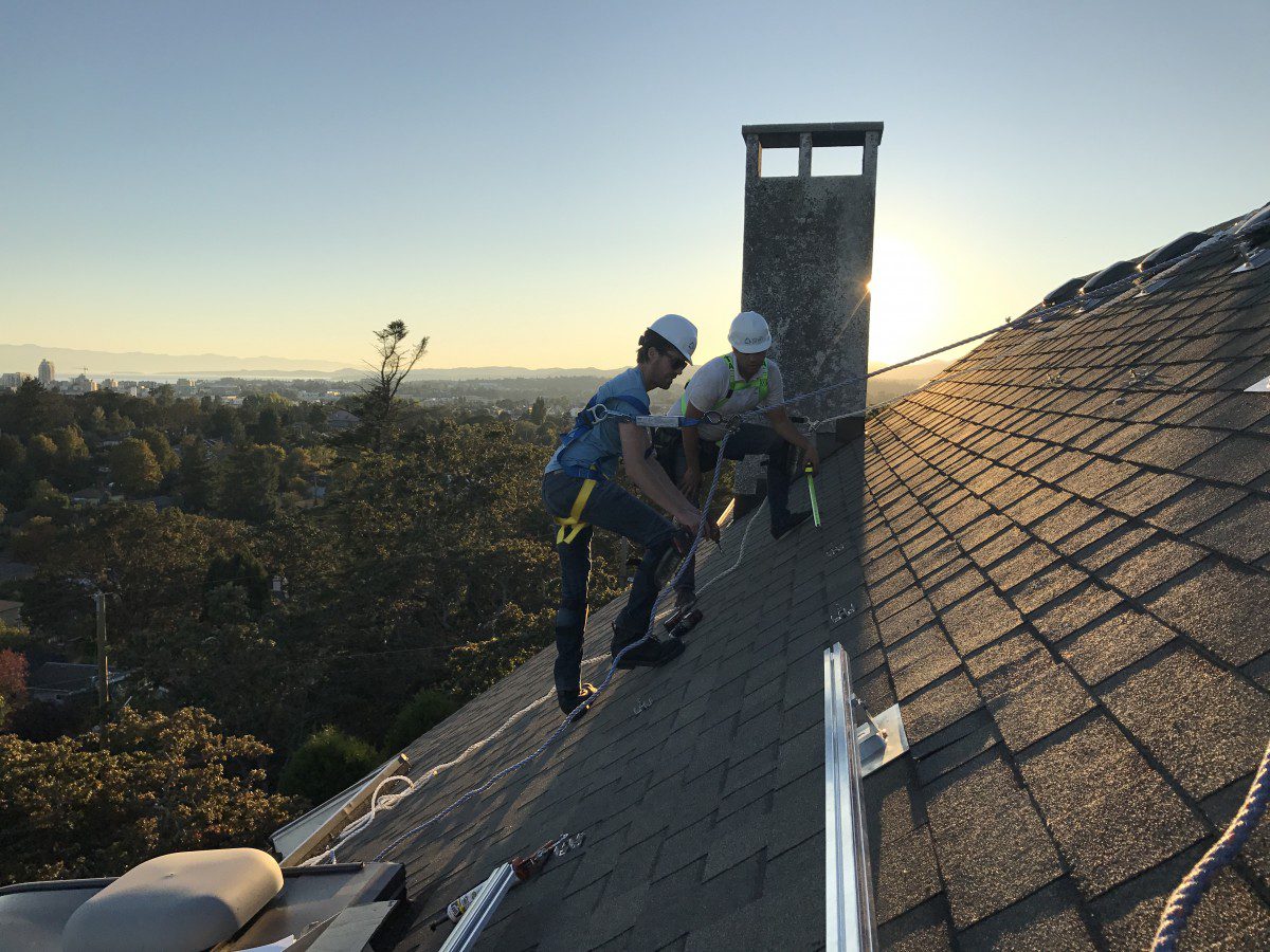 Rooftop view of two solar Installers on the roof of a home.